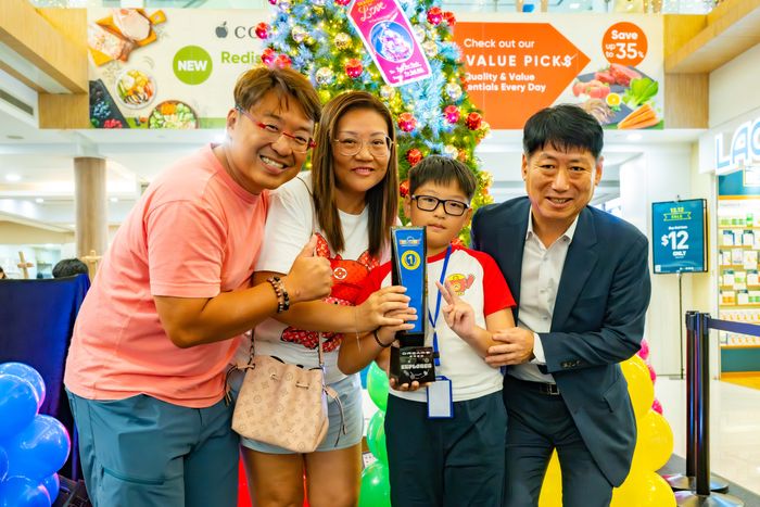 Participant with family celebrating an award